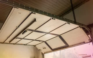 Sectional garage door and track system illustrating professional installation and repair services